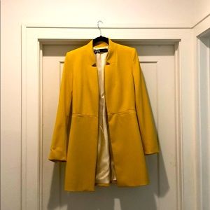 Yellow blazer/coat.